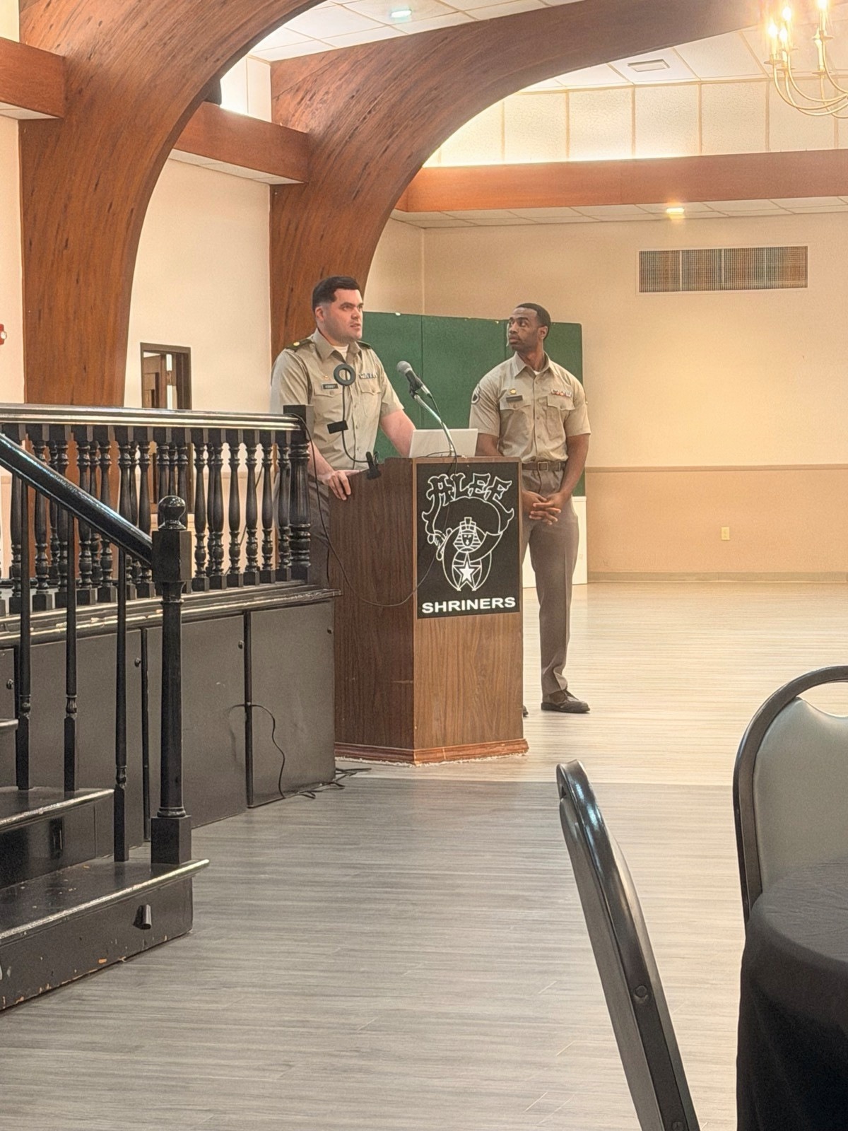 Two Army contracting personnel stand at a lectern during a federal contracting workshop for local businesses.